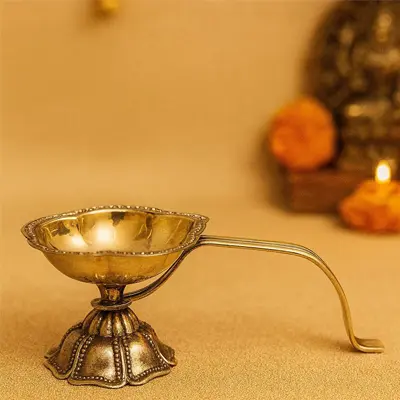 Brass diya with handle by Metals & Beyond